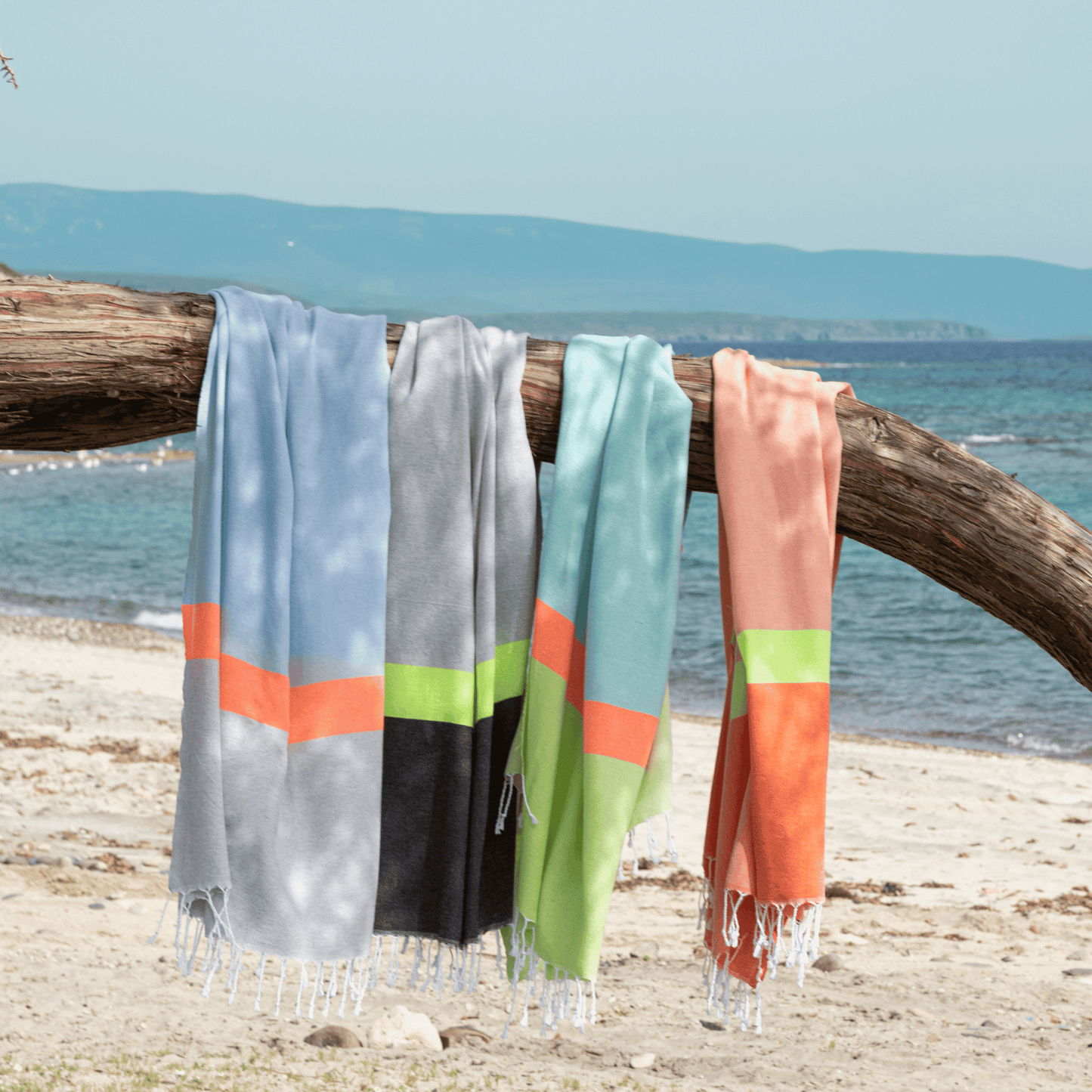 Serviettes de plage rayées bleu clair, gris, vert et rose, bords frangés