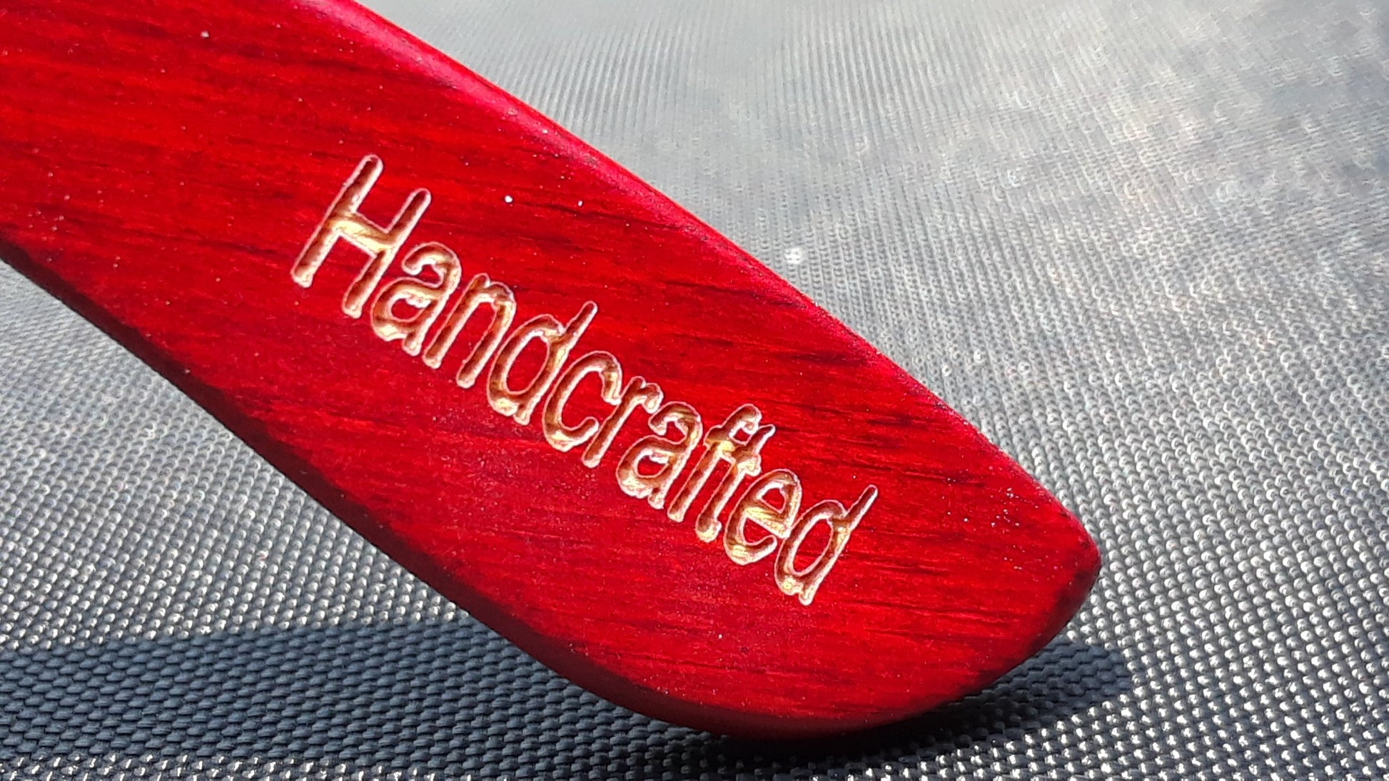 Branche de lunettes Engleberts rouge gravée, inscription « Handcrafted »