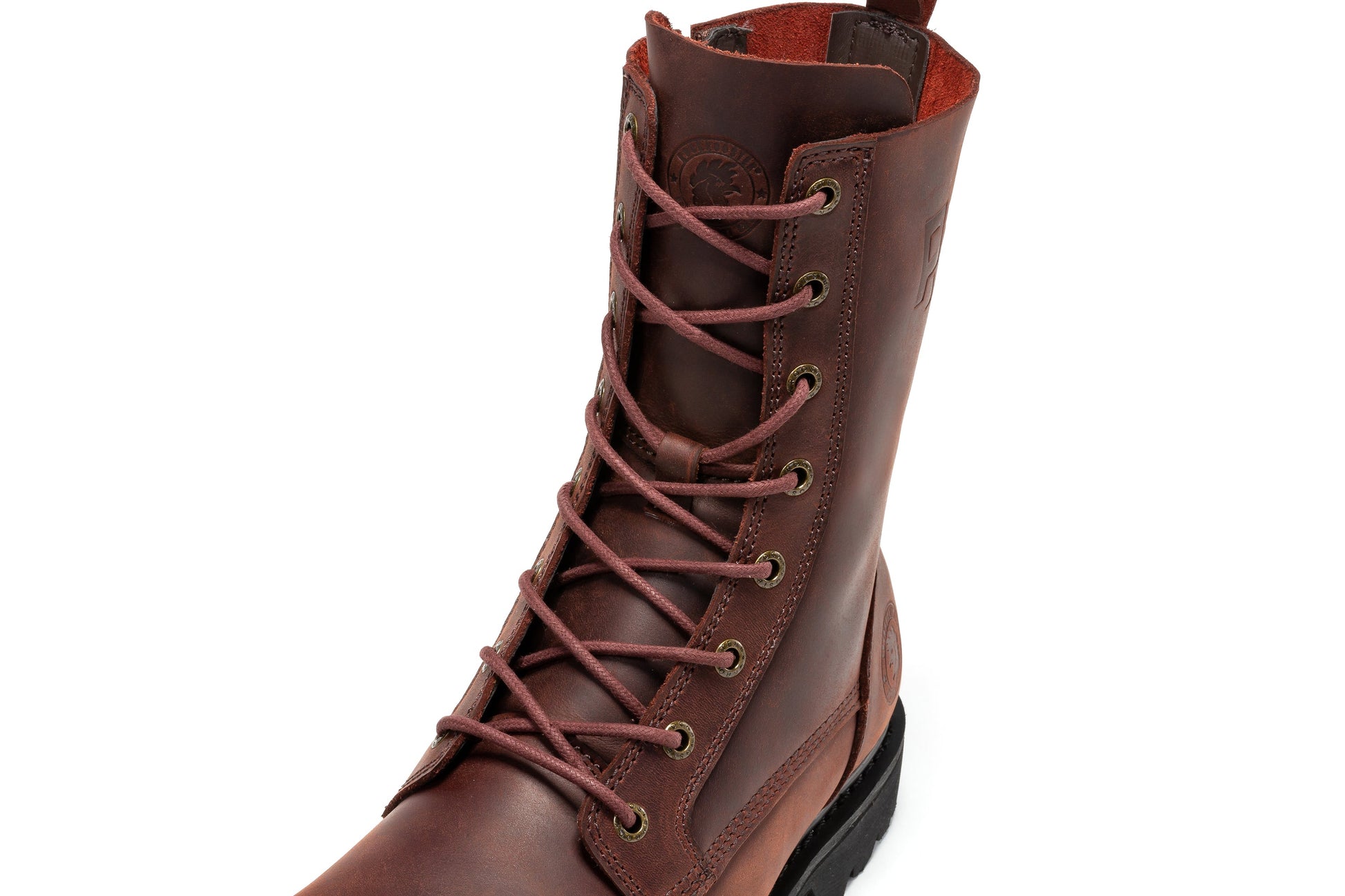Botte en cuir marron, gros plan sur lacets et œillets avec intérieur doublé rouge