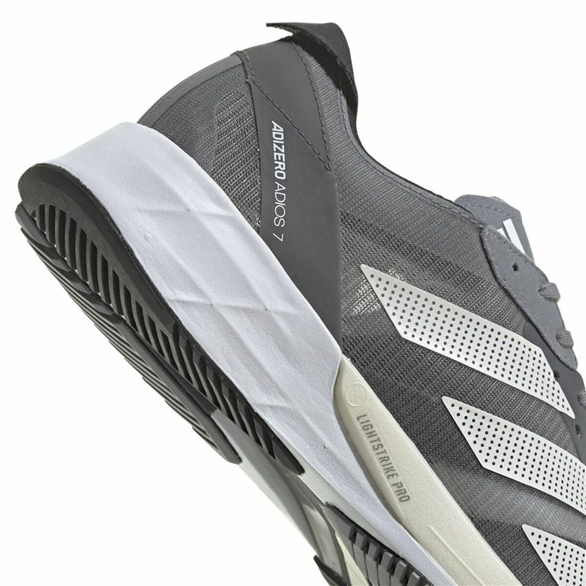 Chaussure de running adidas grise foncée, semelle extérieure noire, détail semelle blanche