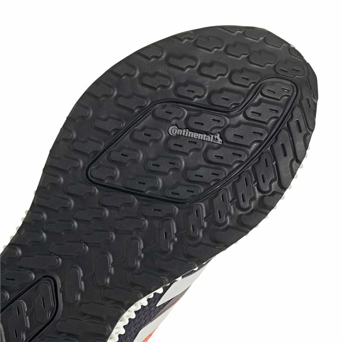 Semelle extérieure crantée noire Adidas, motif en relief, logo Continental au centre.