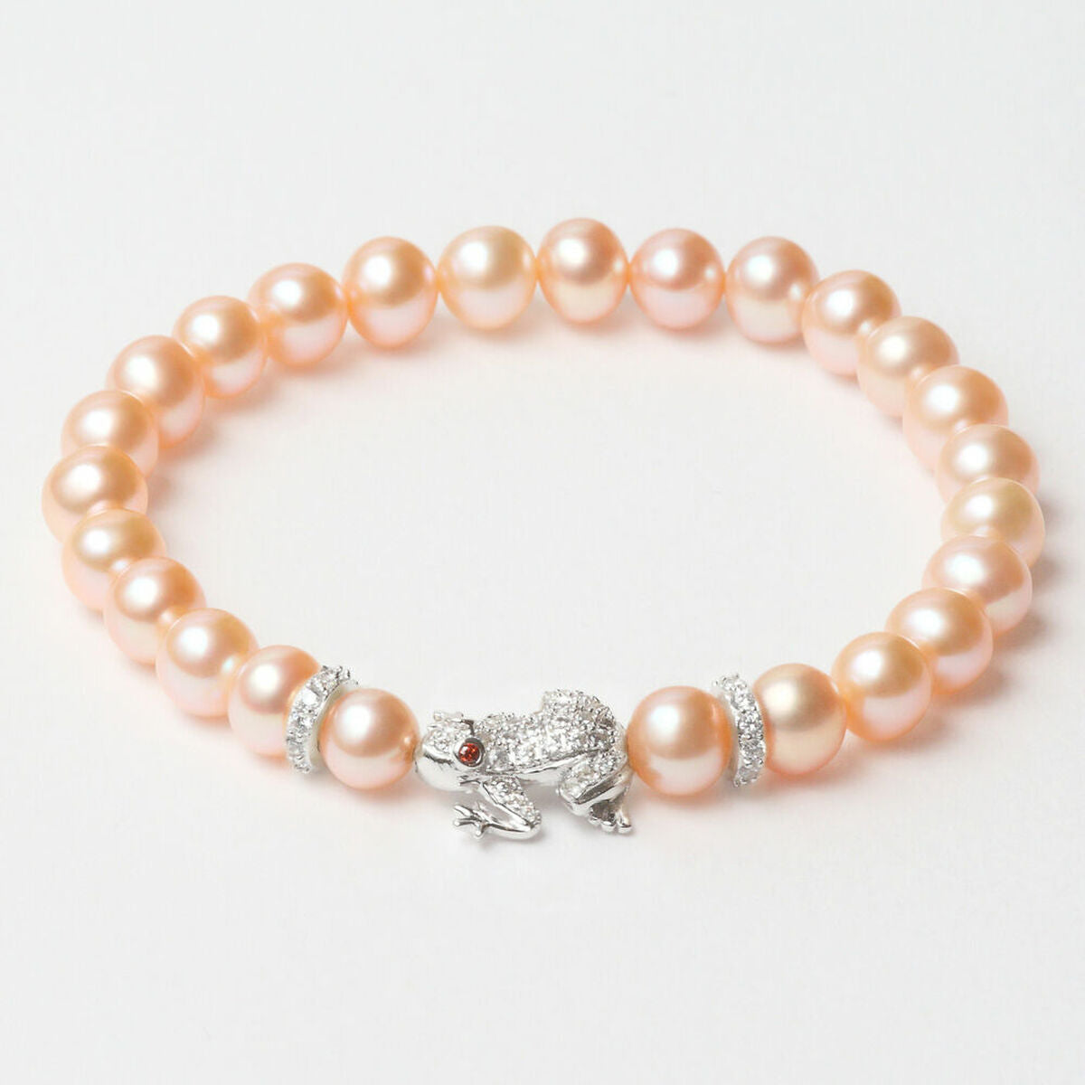 Bracelet Lancaster en perles rose avec pendentif argenté et trois breloques serties.