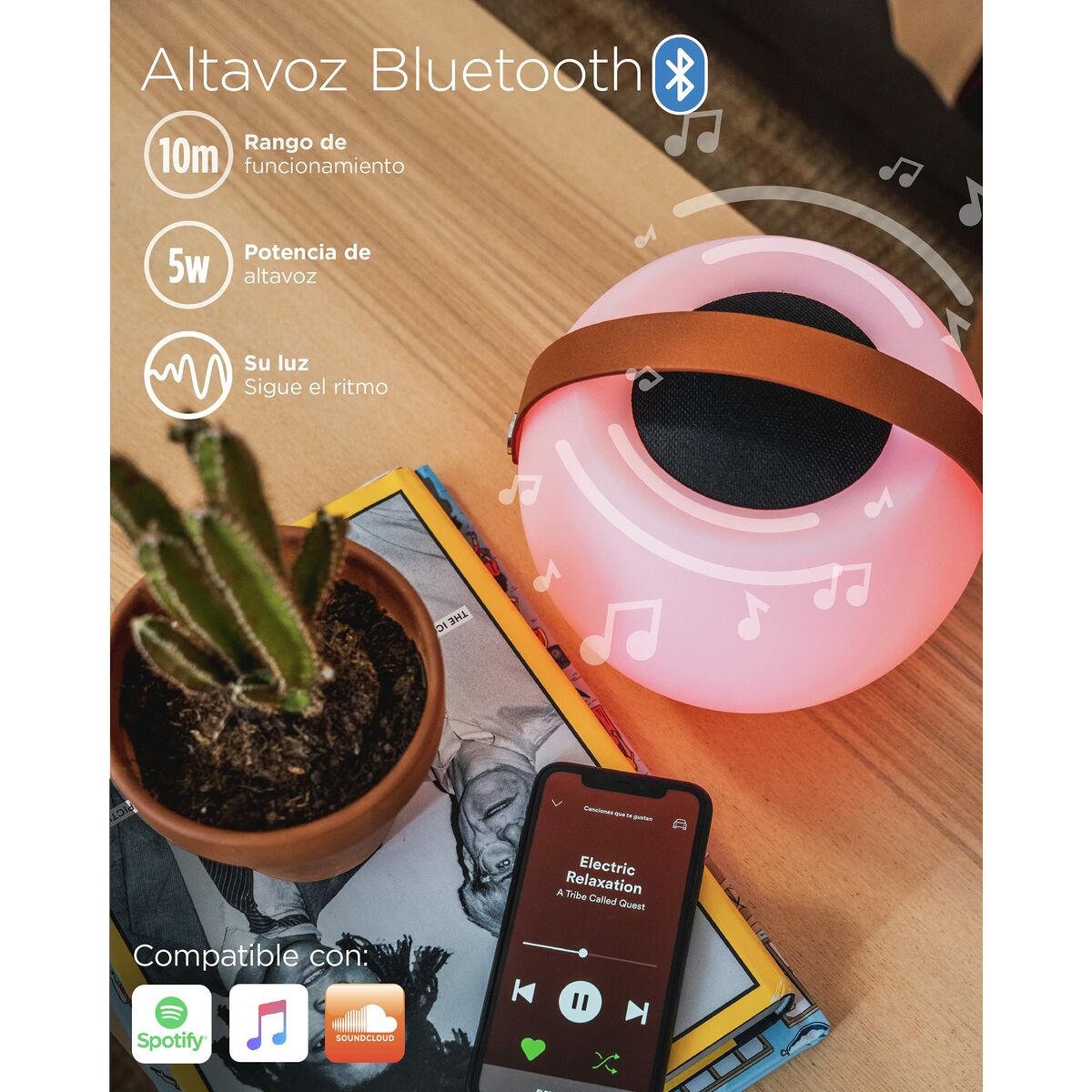 Enceinte Bluetooth portable rose avec lumière, grilles noires et poignées, sur table.