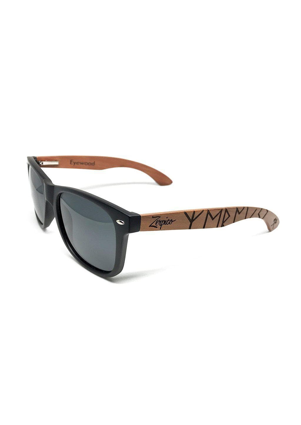 Lunettes de soleil avec branches en bois gravées et verres sombres, vue de profil