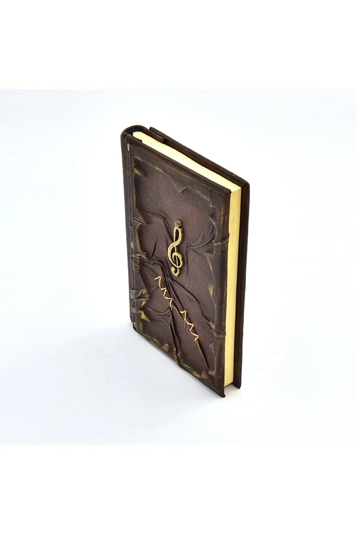 Carnet en cuir brun foncé, vue de côté, tranche dorée et clé de sol gravée