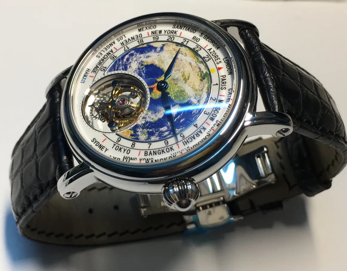 Montre homme cadran globe bleu, boîtier métal poli, bracelet cuir noir à texture croco