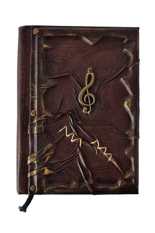 Carnet en cuir veau brun foncé avec motif doré et clé de sol au centre
