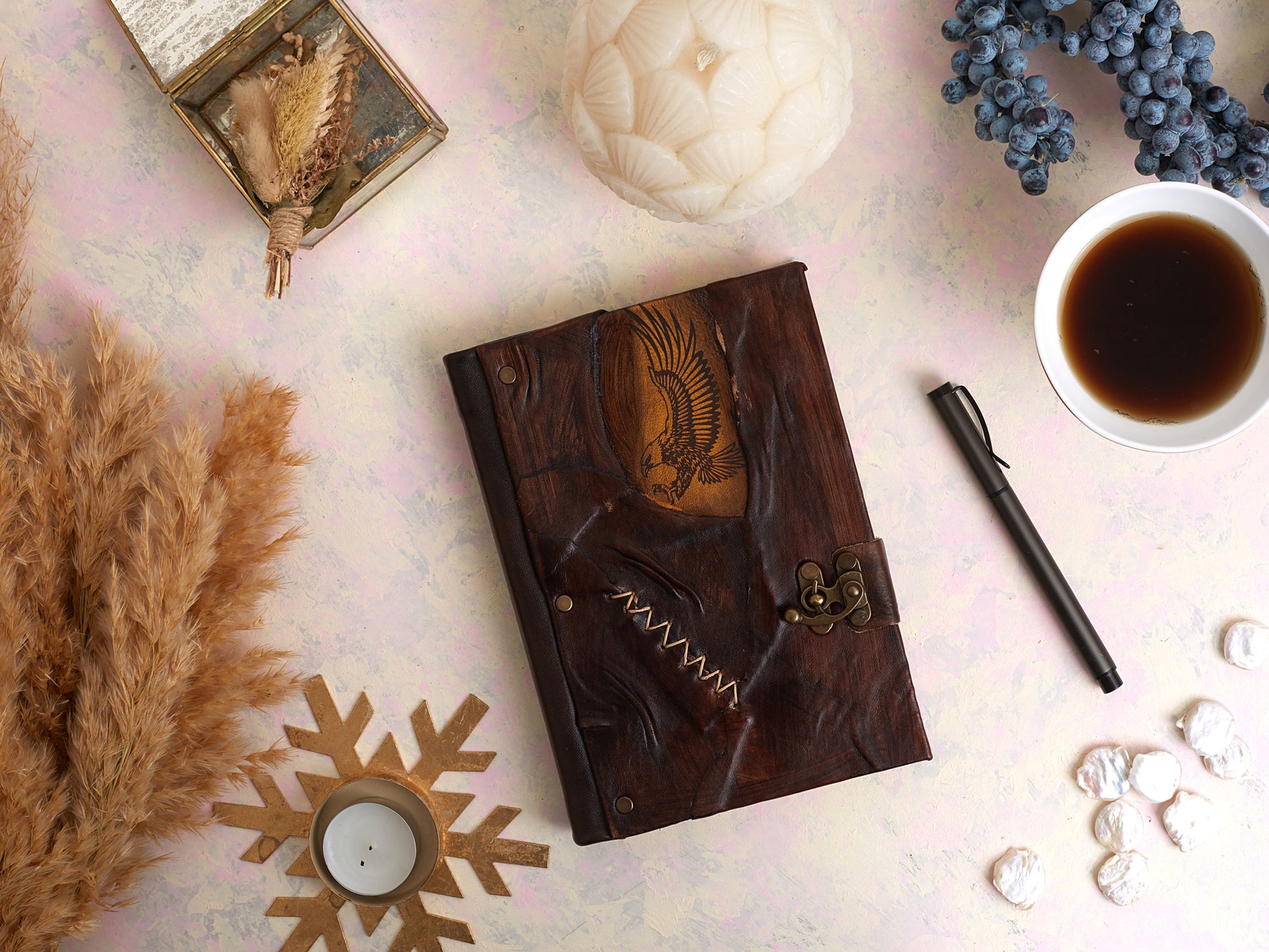 Carnet en cuir marron motif aigle doré, couture zigzag et attache bronze.