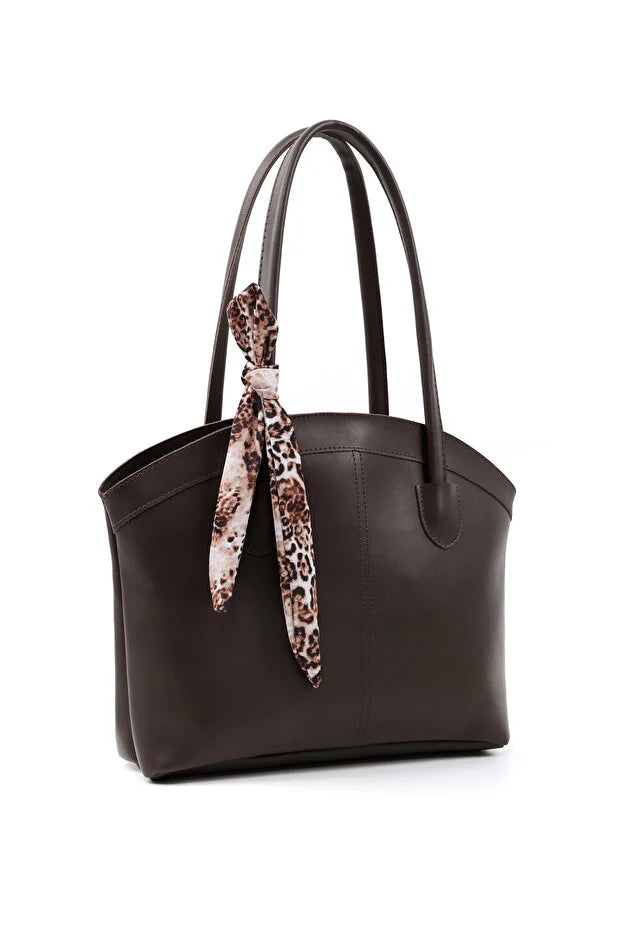 Sac en cuir synthétique marron avec ruban imprimé léopard noué sur la poignée.