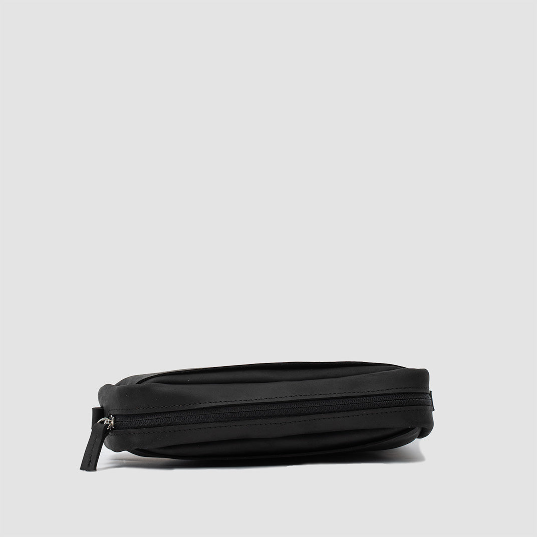Mini sac besace en cuir noir, vue latérale avec rabat zippé