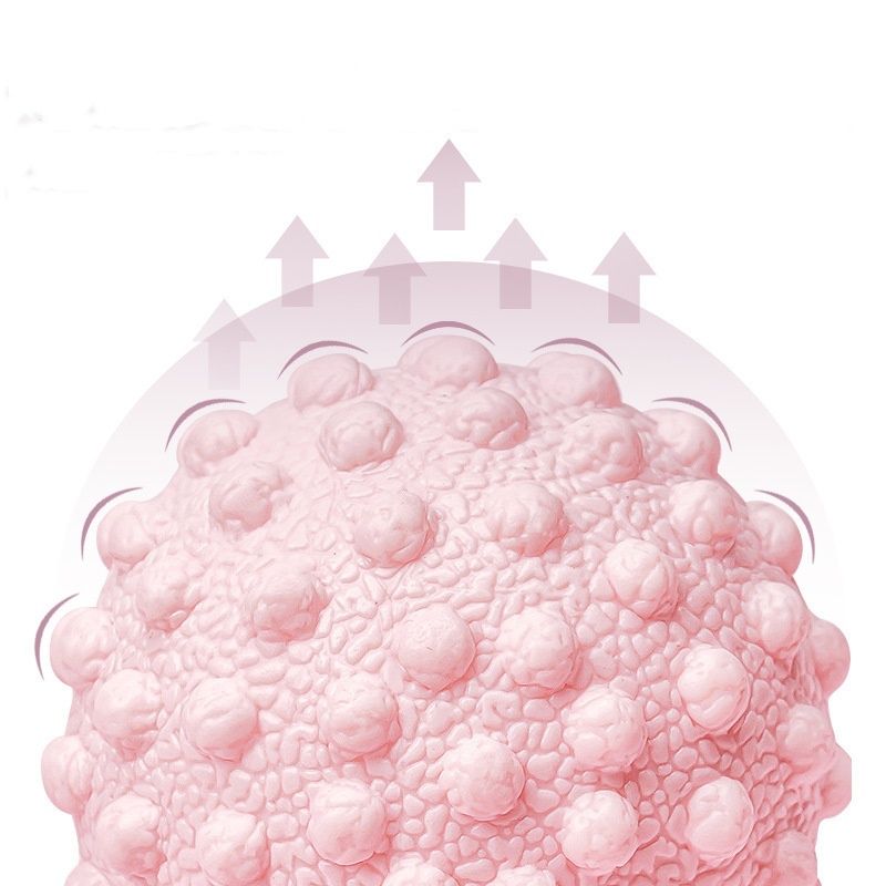Balle de massage de yoga rose à picots, texture granuleuse en relief.