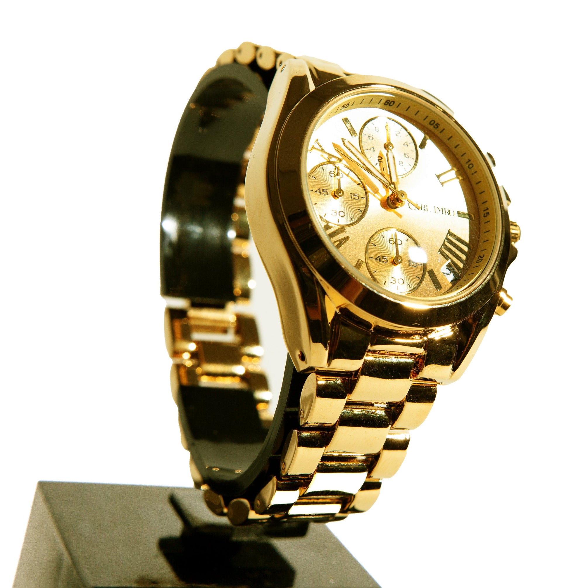 Montre femme gros plan, cadran doré à sous-cadrans et bracelet maillons dorés.