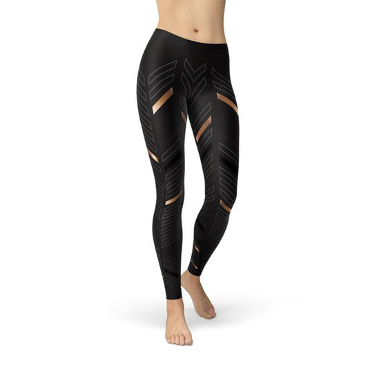 Leggings de sport noirs avec motif rayures géométriques dorées sur les jambes