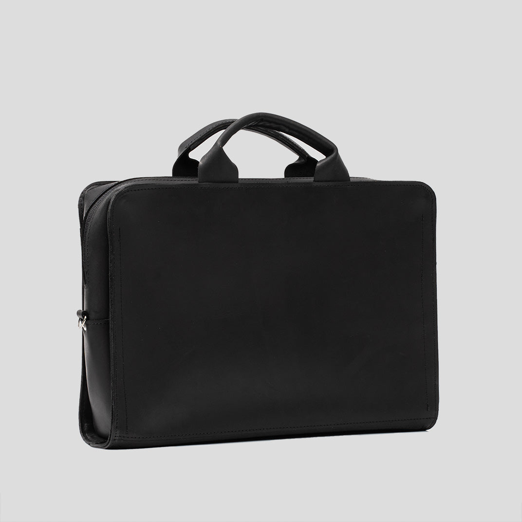 Sac ordinateur en cuir noir avec poignée supérieure et fermeture éclair latérale