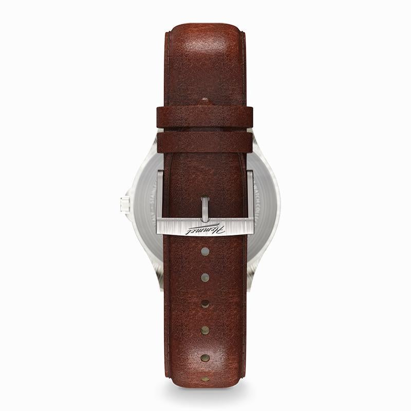 Montre H|Watch Série 2 bracelet en cuir brun et boîtier argenté, vue de dessus.