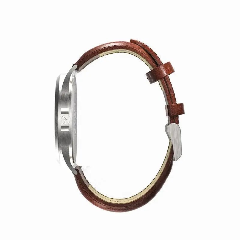 Montre H|Watch Série 2 vue de profil : boîtier argenté et bracelet en cuir brun.
